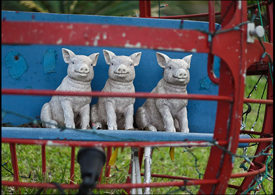 Three little pigs, salvaged carnival ride seat by Daniel Feeser