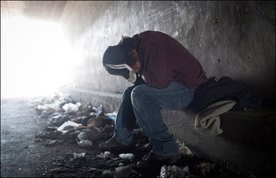 A homeless man tries to rest inside a Tijuana River canal tunnel, in Tijuana, Mexico, on June 22, 2011 (AP Photo/Alejandro Cossio).
