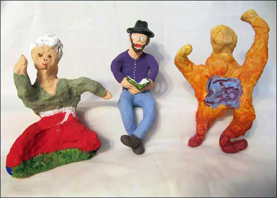 three clay figures created by members